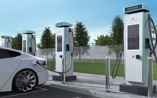 A row of PowerNode EV charging stations behind a parked vehicle.