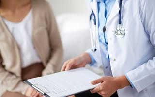 doctor with clipboard talking to patient