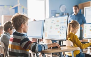 child in classroom using a computer