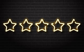 A neon sign depicting five yellow stars glow on a black brick background.