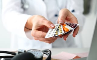 A pharmacist fans out packets of prescription pills.