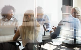 stylized image of a board room with people form diverse backgrounds sitting around a table