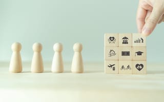 Wooden blocks and figurines depicting the various aspects of an employee benefits package