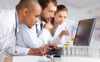 Healthcare team study computer monitor