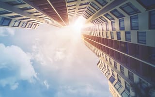 A photo of tall buildings from a ground perspective.