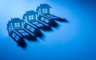 A paper cutout of a row of homes is pictured.