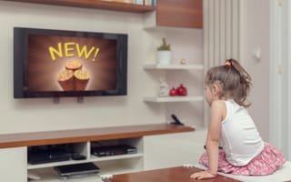 A young person watches an advertisement on TV.
