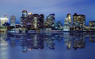 A nighttime photo of the Boston skyline.