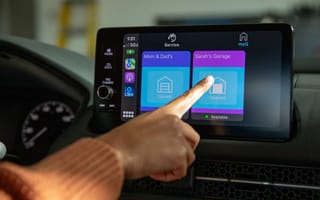 A driver uses a touchscreen app to manipulate their garage door.