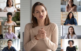 Screen shot of woman in beige sweater in center panel with eight smaller screens of people flanking her.