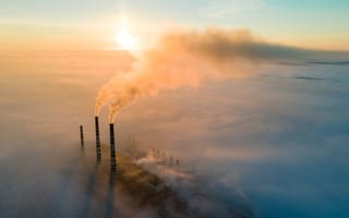 A smokestack emitting CO2 is pictured.