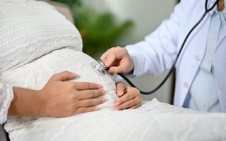 A pregnant patient is shown receiving a checkup.