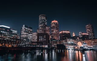 Boston skyline from the harbor at night.