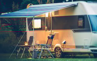 A camping trailer set up outside is pictured.
