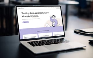 A laptop open on a desk with the SimpleClosure website pulled up.