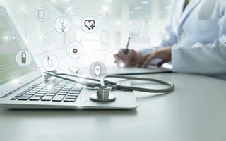 A stethoscope sitting on a laptop is pictured.