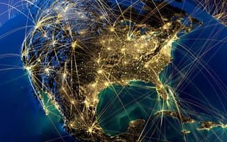 An illuminated network of connections spans across the North American continent, symbolizing a web of communication and technology.