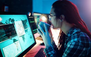 Computer screen, coffee or cyber security woman hacker in dark room for coding.