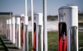 A row of Tesla charging stations is shown.