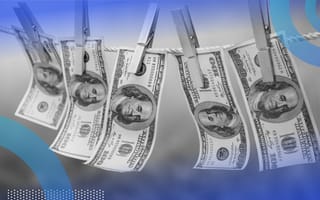 Five $100 bills clipped to a clothesline.