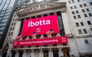 A banner bearing Ibotta's logo is shown draped over the New York Stock Exchange building.
