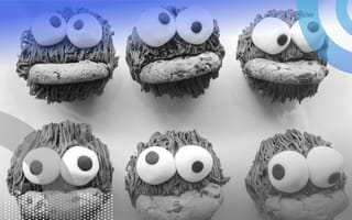 Six Cooke Monsters with googly eyeballs are eating cookies .