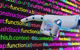 A computer screen with lines of code on it, with a robot hand pointing a finger at the screen.
