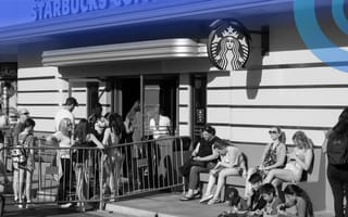 Customers are lined up outside of a Starbucks store.