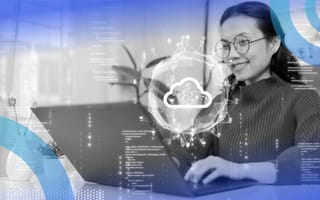 A woman working on a laptop with a holographic symbol of a cloud and various code superimposed over her.