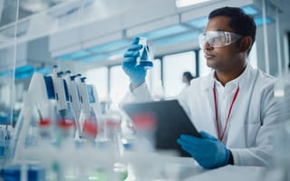 A scientists examines a lab specimen.