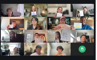 A virtual call with 11 Pluralsight team members holding up drawings.
