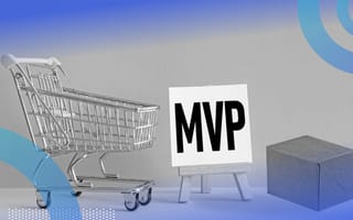 A shopping cart, a white sign on an easel with “MVP” written on the canvas in black block letters and a plain cardboard box.