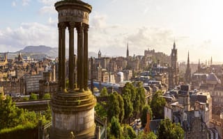 A skyline view of Edinburgh taken from the circular Dugald Stewart Monument that overlooks the city.