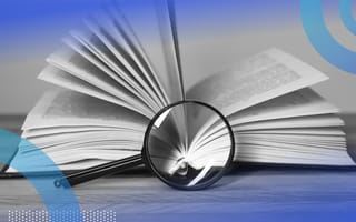 magnifying glass searching text in an open book