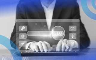 Hands are typing on a computer keyboard with the word SEO hovering above.