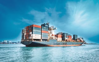 A multicolored cargo ship leaves the port of Chennai.