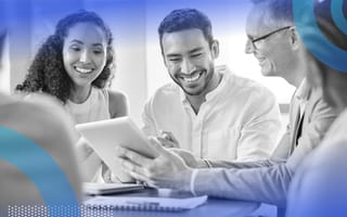 Happy employees are sitting at a table.