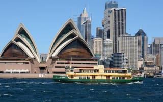 Sydney cityscape from the water, the Opera House is visible in the foreground