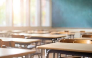 Blurred background of an empty classroom.