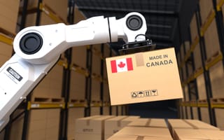 A robot arm lifting a box of products made in Canada.