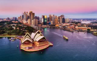An aerial view of Sydney, Australia taken above the water at the Sydney harbor.