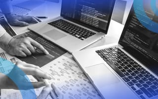 Developers reviewing code on laptop