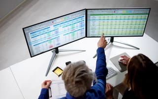 Data scientists analyze a spreadsheet.