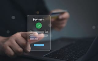 A close up of a hand hovering over a digital illustration featuring the world "Payment" to represent the fintech industry.