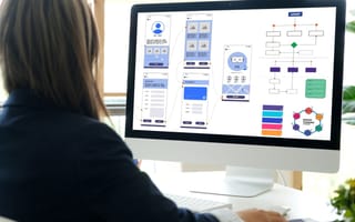 person looking at wireframes on screen