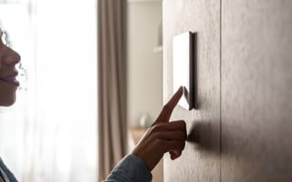 person using smart thermostat