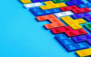 Illustrative grid of icons representing people fitting together as a puzzle.