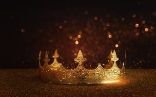 Gold crown layered over black background.