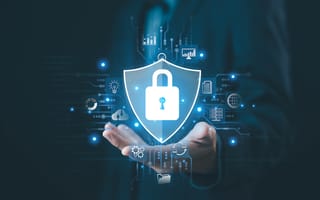 Image of a glowing lock and shield hovering above an open hand.