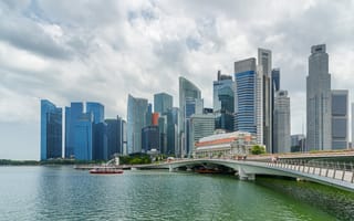 A view of the downtown Singapore skyline featuring several skyscrapers along the water.